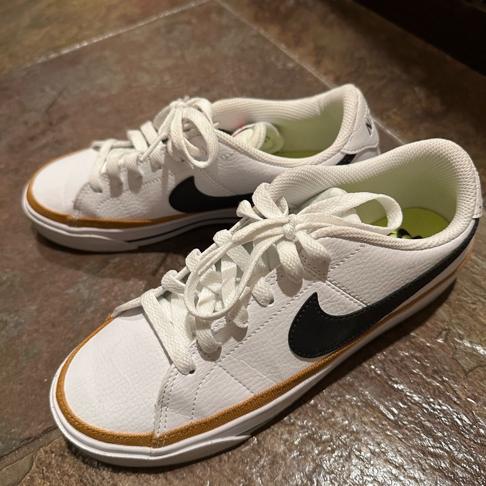 Nike White and Black Sneakers with Gold Trim